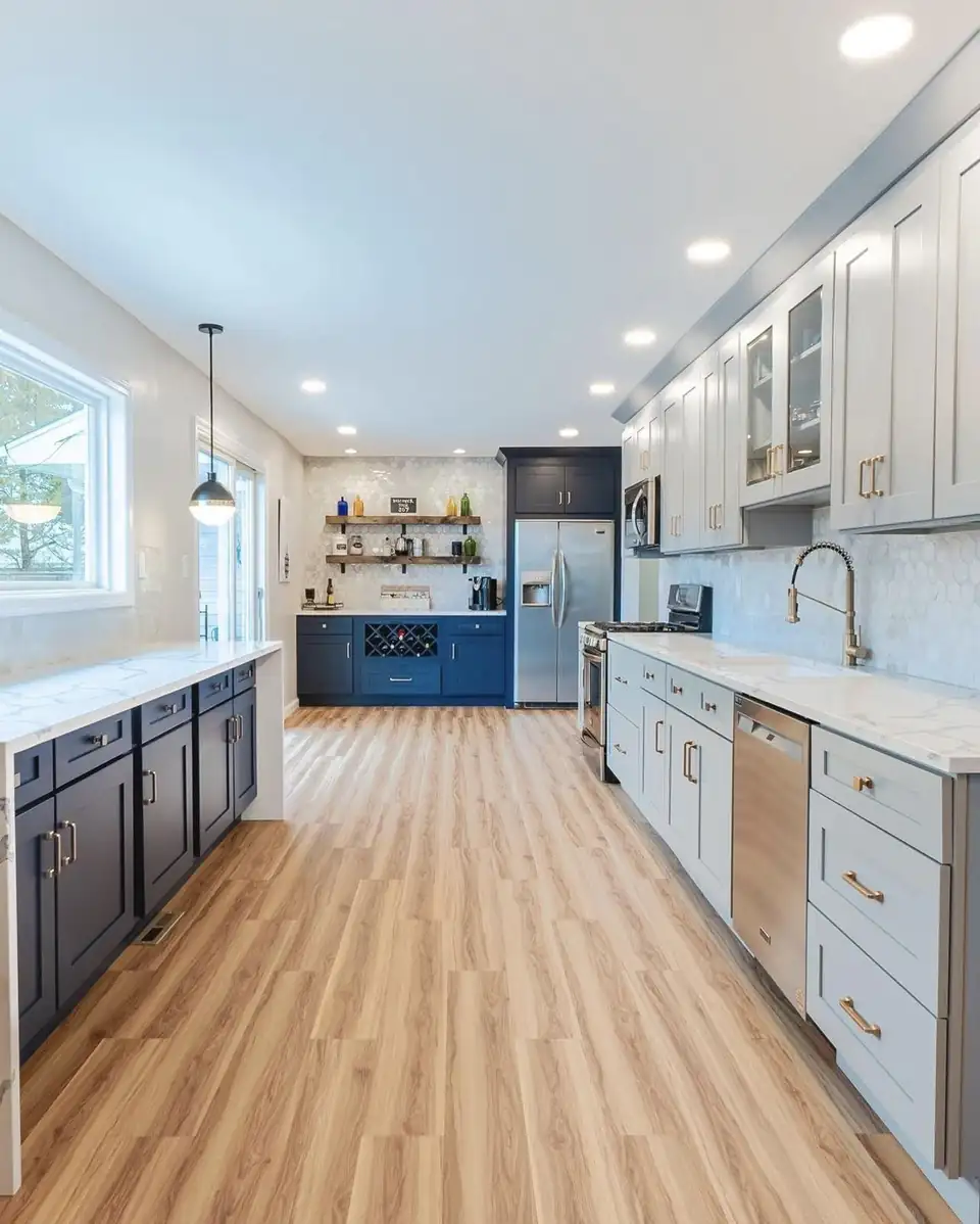 Kitchen remodeling in Elizabeth, NJ: two-tone navy and light grey shaker kitchen with white marble-look counters, a hexagon tile backsplash and gold pulls